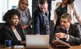 Professionals in discussion with financial and compliance experts